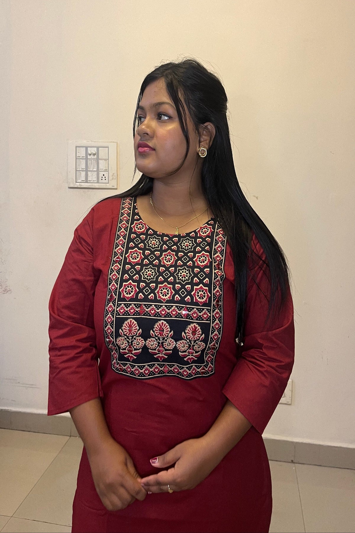 designer maroon kurti with floral motifs